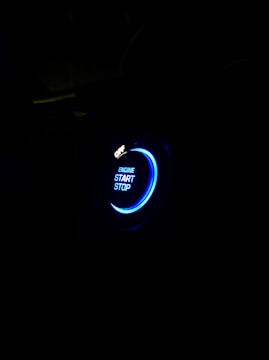 Electric blue glowing button on a dark background inviting campaign launch.