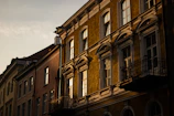 A charming historic European hotel facade bathed in warm evening light.