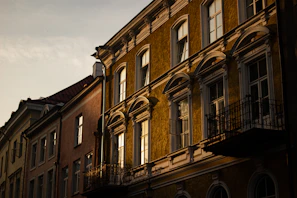 A charming historic European hotel facade bathed in warm evening light.