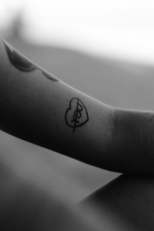 Minimalist geometric tattoo on the wrist with clean sharp lines.