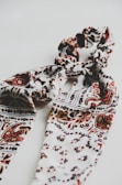 A stylish scarf featuring hand-drawn patterns inspired by nature.