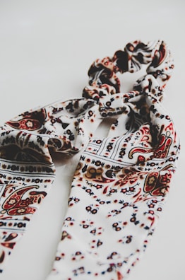 A stylish scarf featuring hand-drawn patterns inspired by nature.