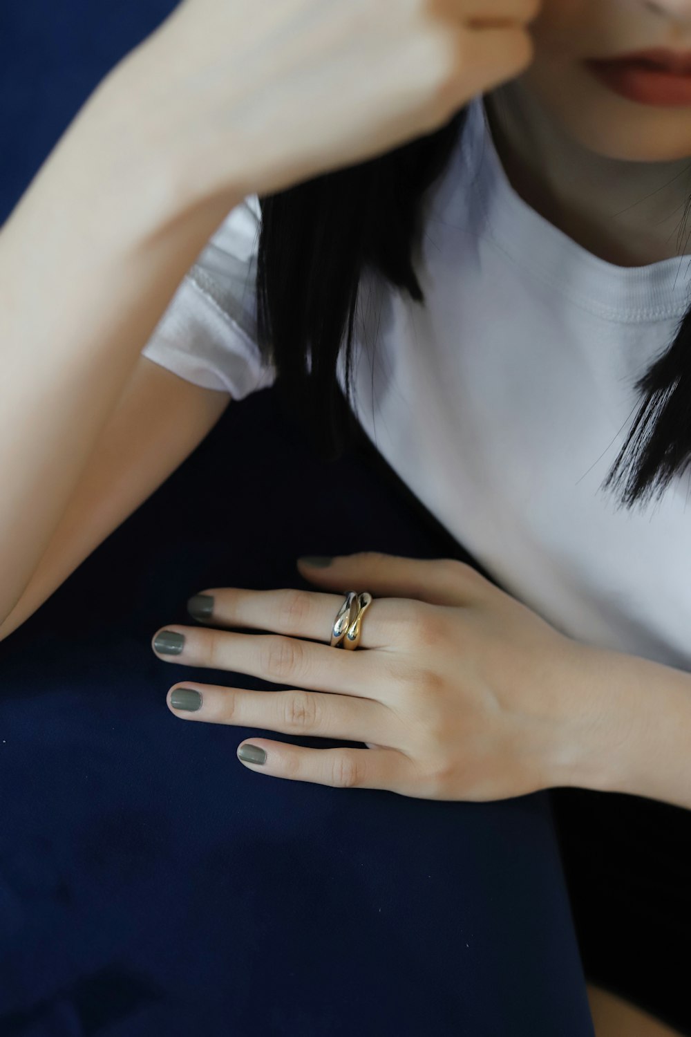 woman in white v neck shirt wearing gold ring