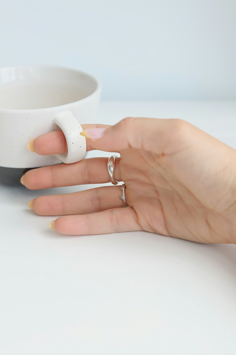 person holding white ceramic mug