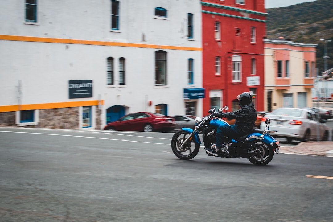 man in black jacket riding motorcycle on road during daytime