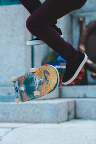 Skateboarder performing a high-speed trick with Kronos Bearings visible on wheels