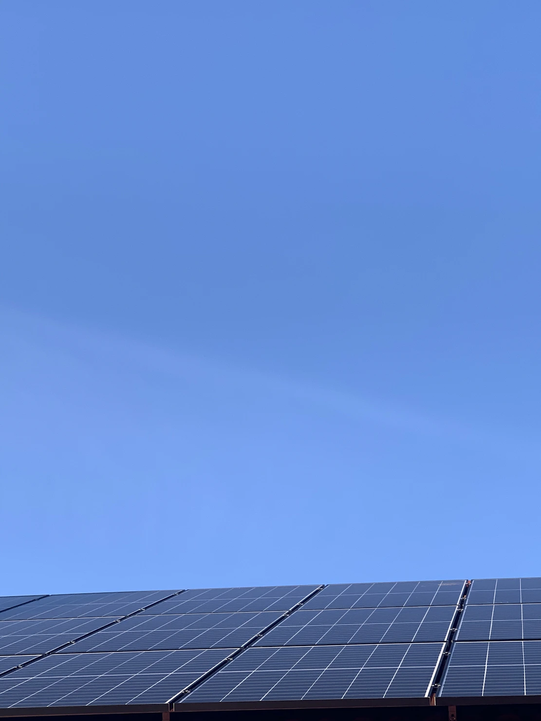 A bright solar panel installation under a clear blue sky symbolizing clean energy.
