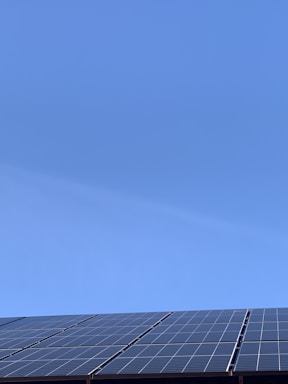 Solar panels installed on a rooftop under a clear blue sky.