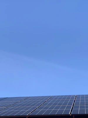 A sleek solar panel glistening under a bright blue sky on a sunny day.