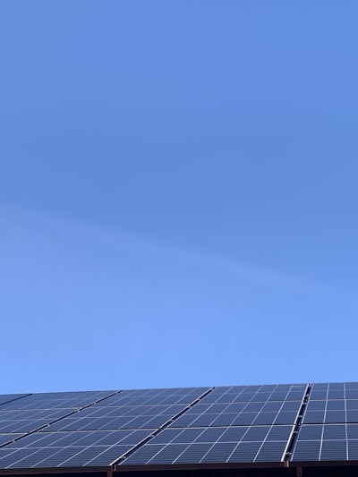A solar power plant with panels under a clear blue sky.
