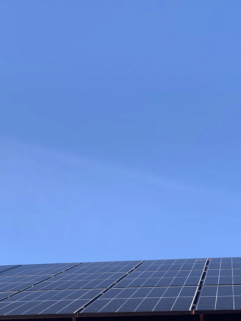 A bright solar panel installation under a clear blue sky symbolizing clean energy.