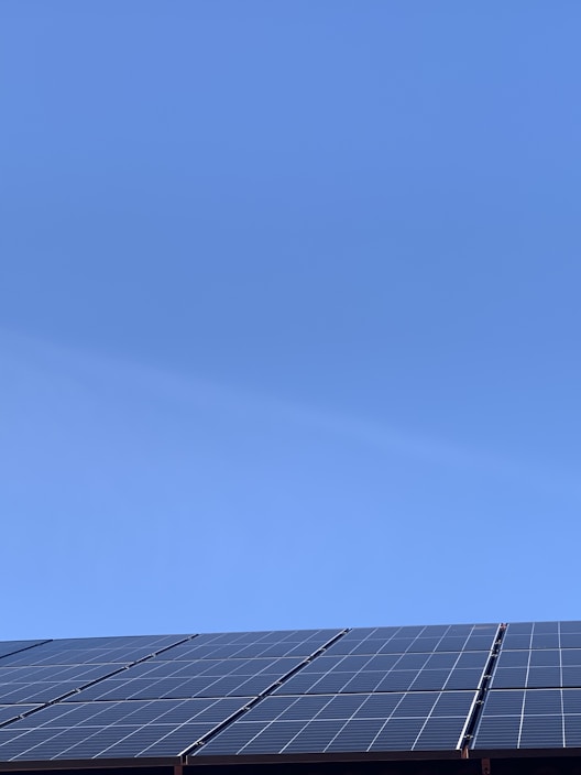 Bright solar panels glistening under a clear blue sky in Sulimanya.