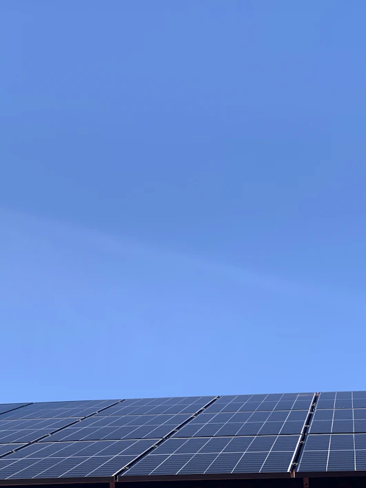 A sleek solar panel angled towards the sun on a clear day.