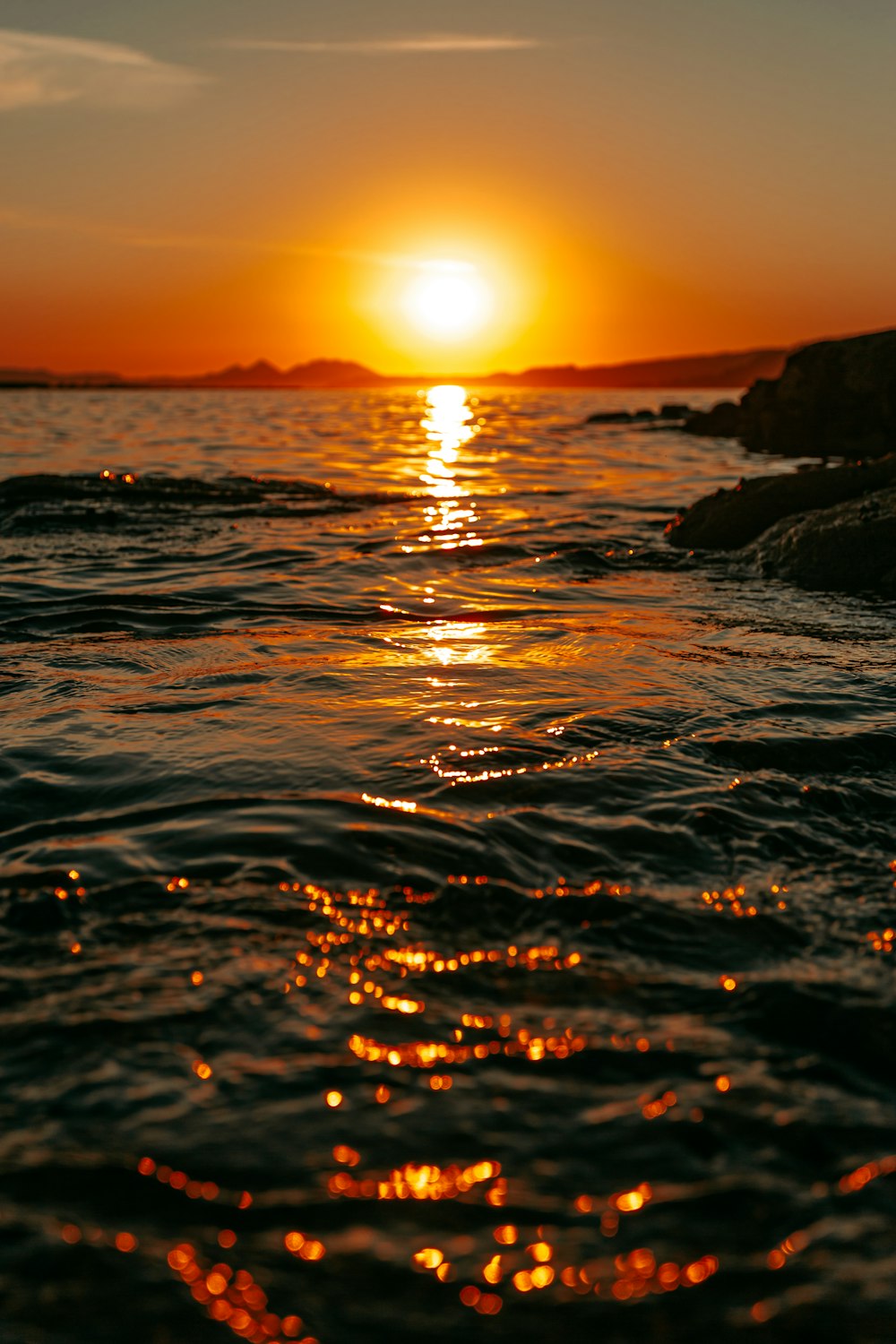 body of water during sunset