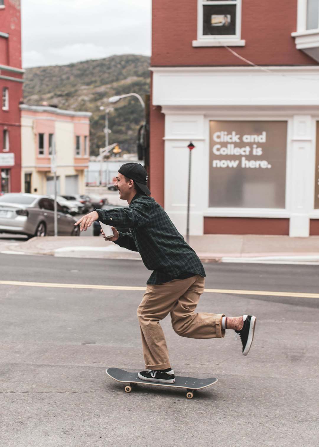man in black shirt and brown pants riding skateboard during daytime