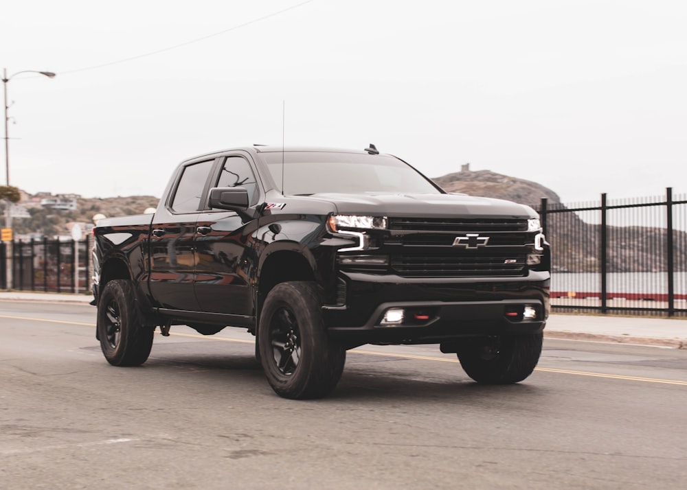 black chevrolet single cab pickup truck on gray sand during daytime