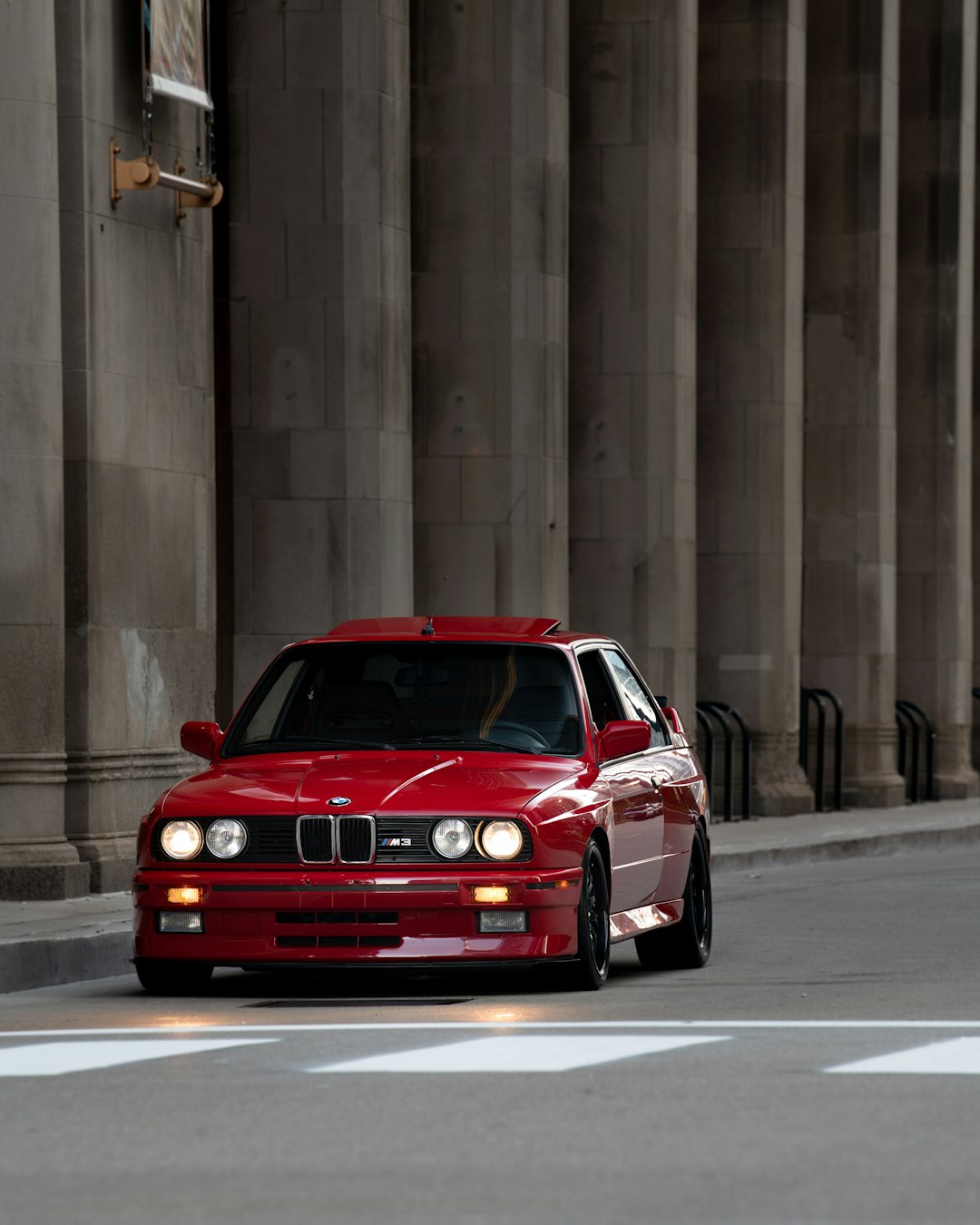 red bmw m 3 on road
