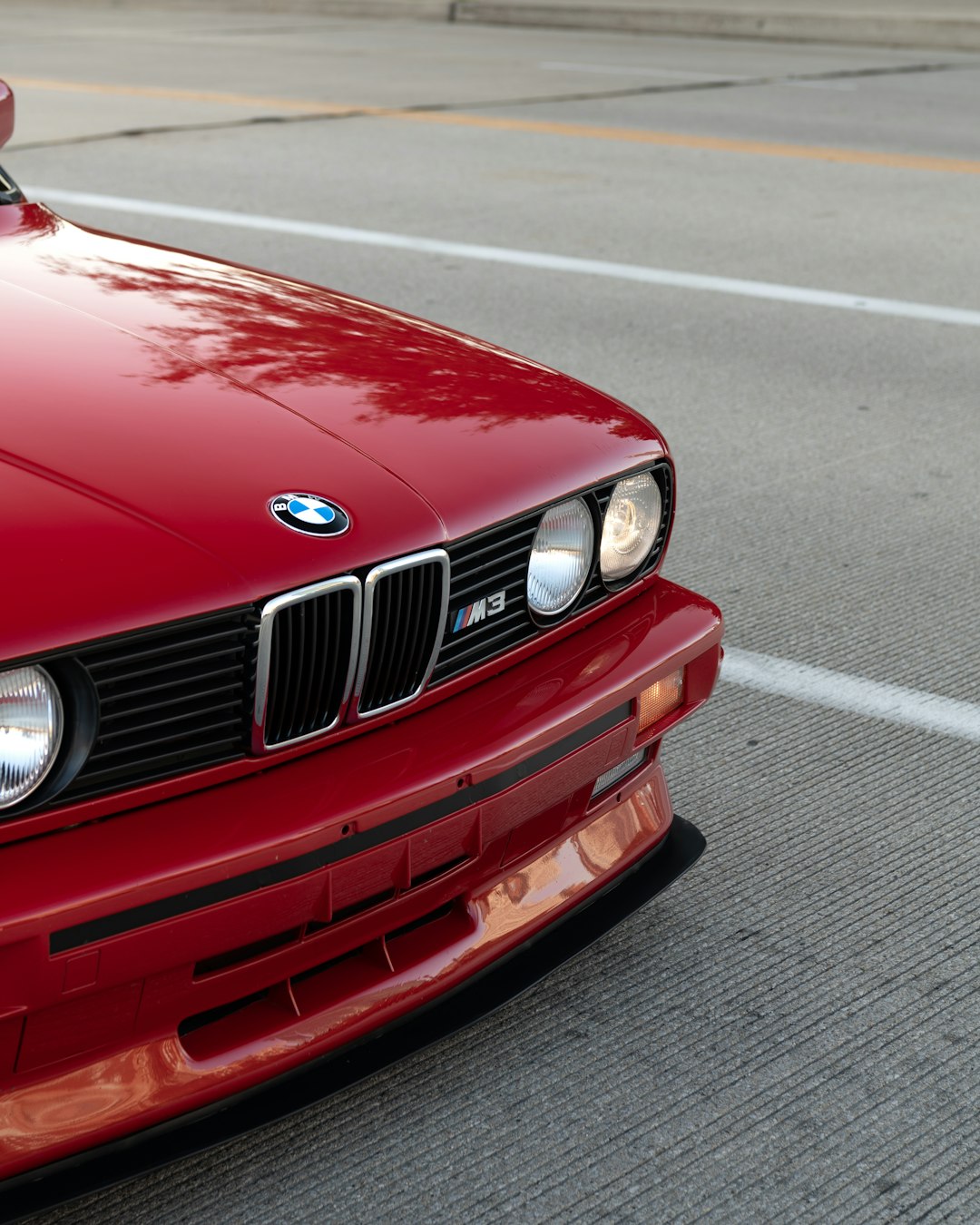 red bmw car on road during daytime