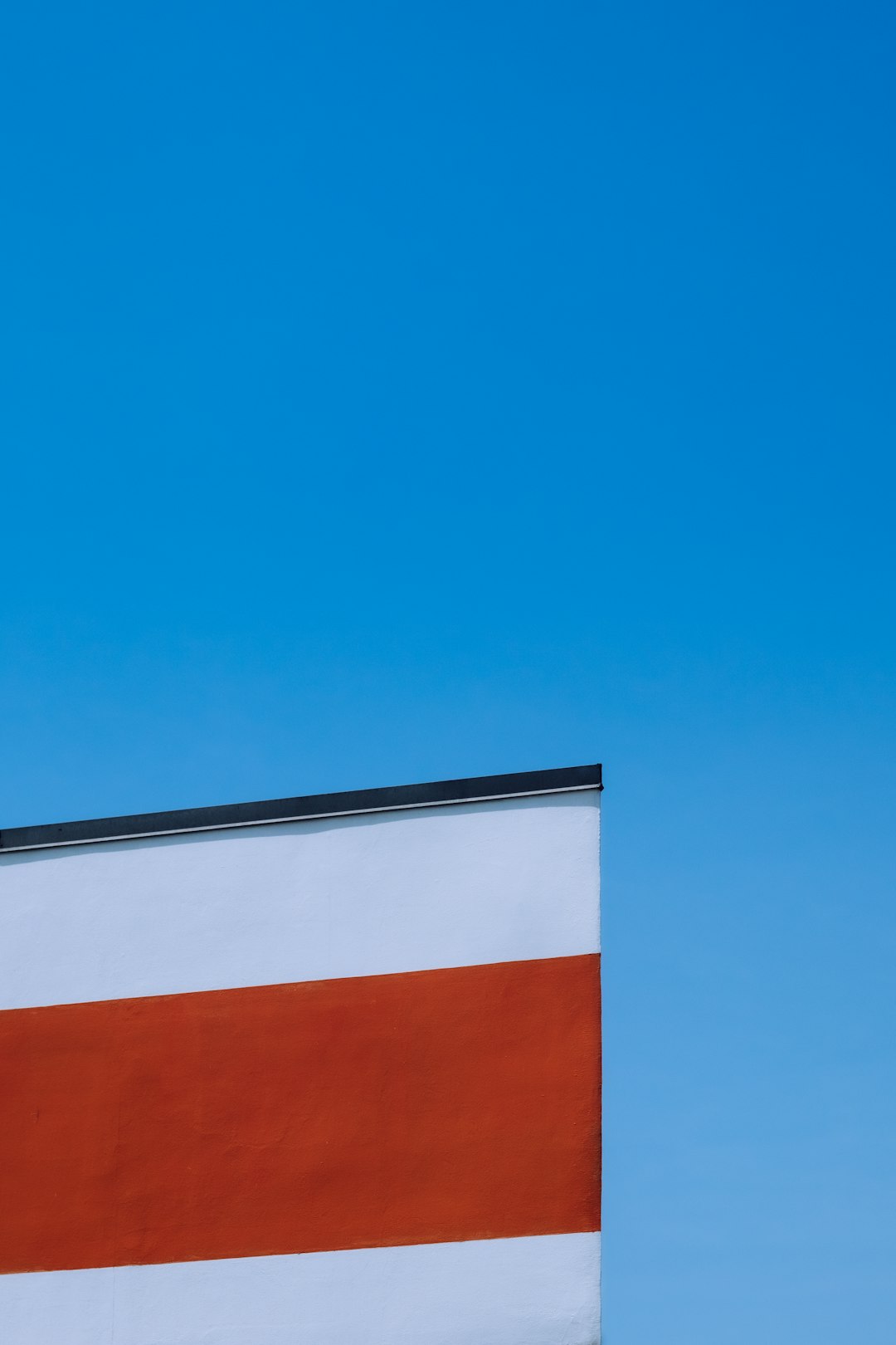 orange and white concrete building under blue sky during daytime