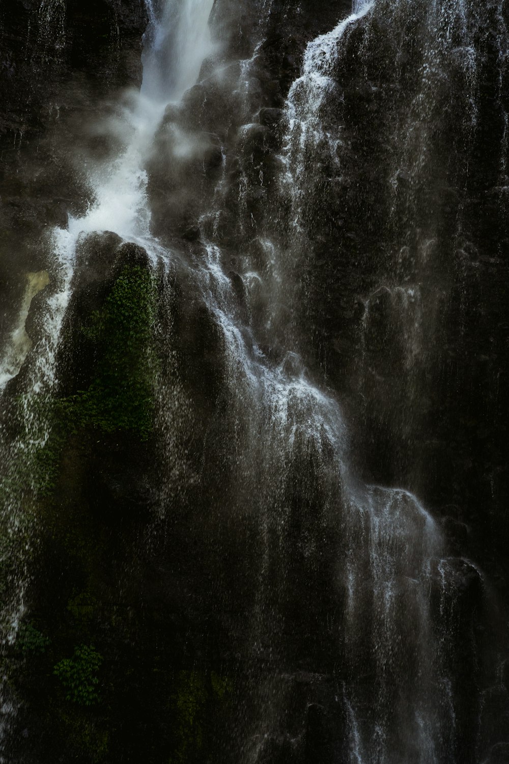 water falls on green grass field