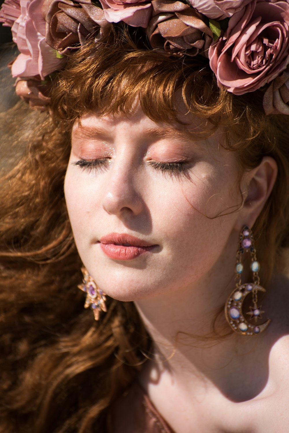 woman with red lipstick and gold earrings