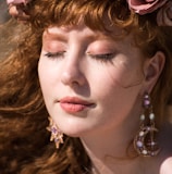 woman with red lipstick and gold earrings