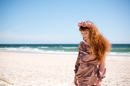 woman in brown long sleeve shirt standing on white sand during daytime in Adelaide SA Australia