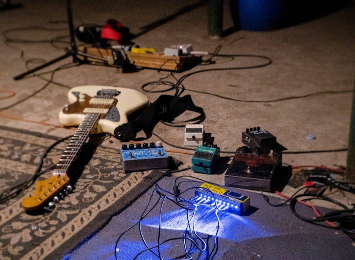 white electric guitar on blue guitar amplifier