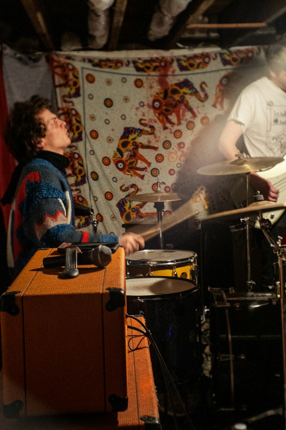 man in white dress shirt playing drum