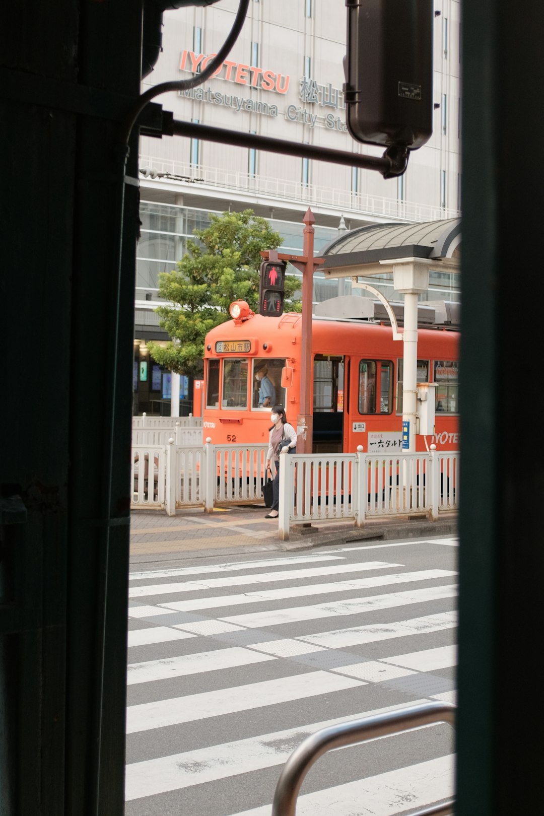 red bus on the street during daytime