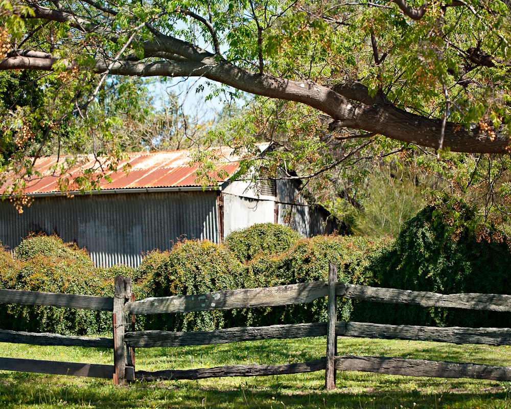 brown wooden fence near brown wooden house during daytime