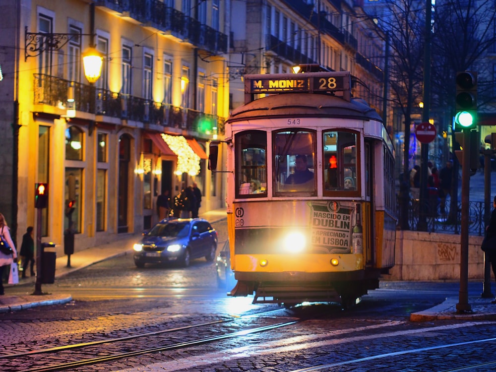 yellow tram on road during night time