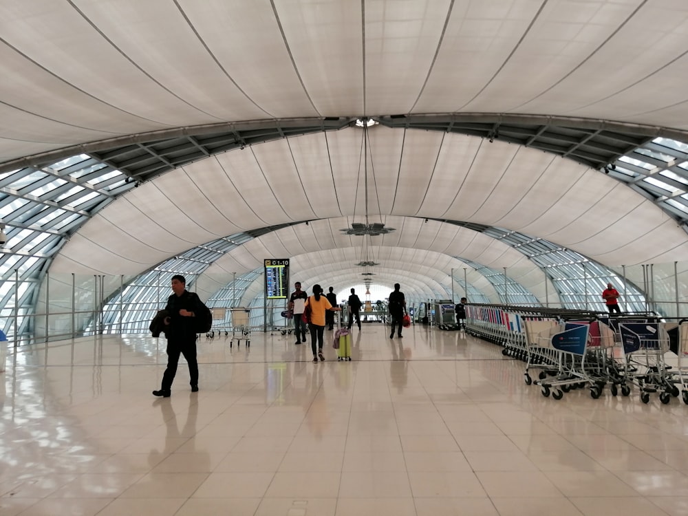 people walking inside white building