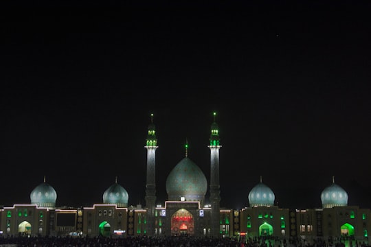 green and brown dome building during night time in Qom Province Iran