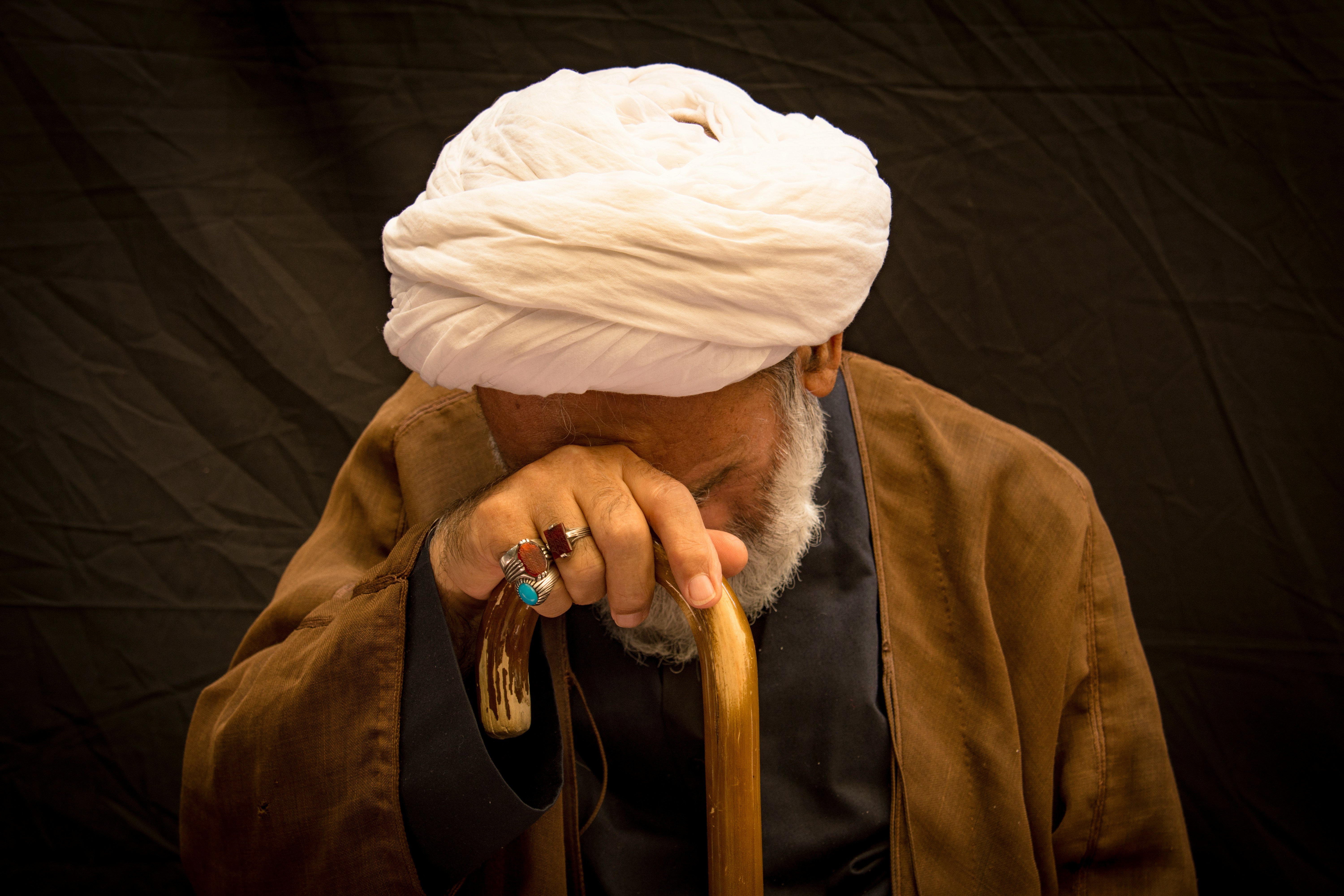 person in brown coat and white knit cap