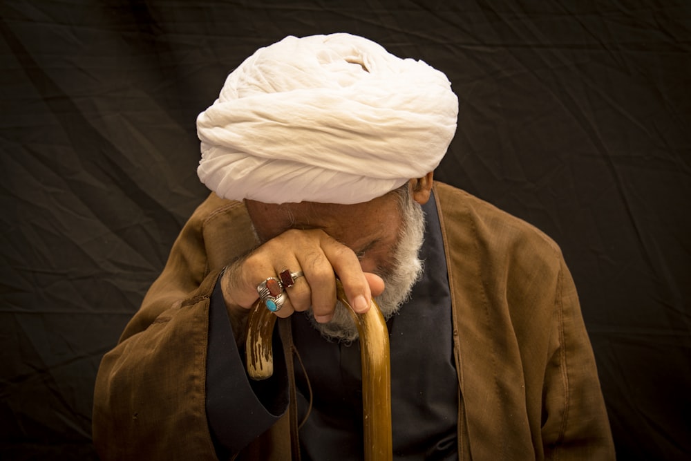 person in brown coat and white knit cap