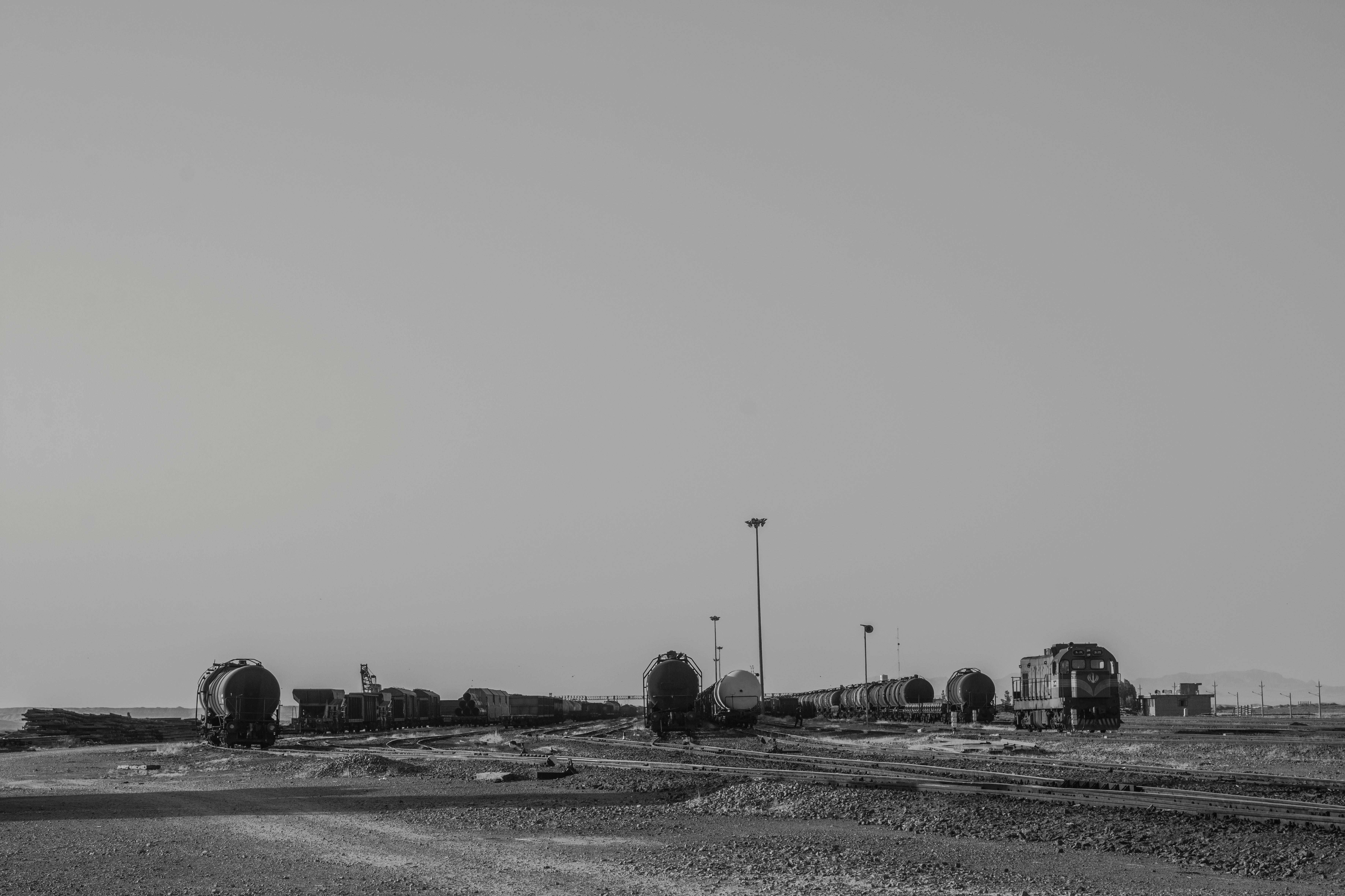 grayscale photo of a city with a river in the distance