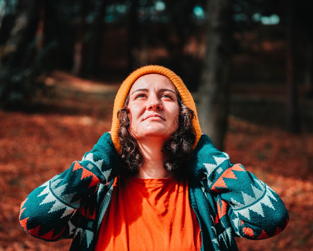 woman in orange and green scarf and orange dress