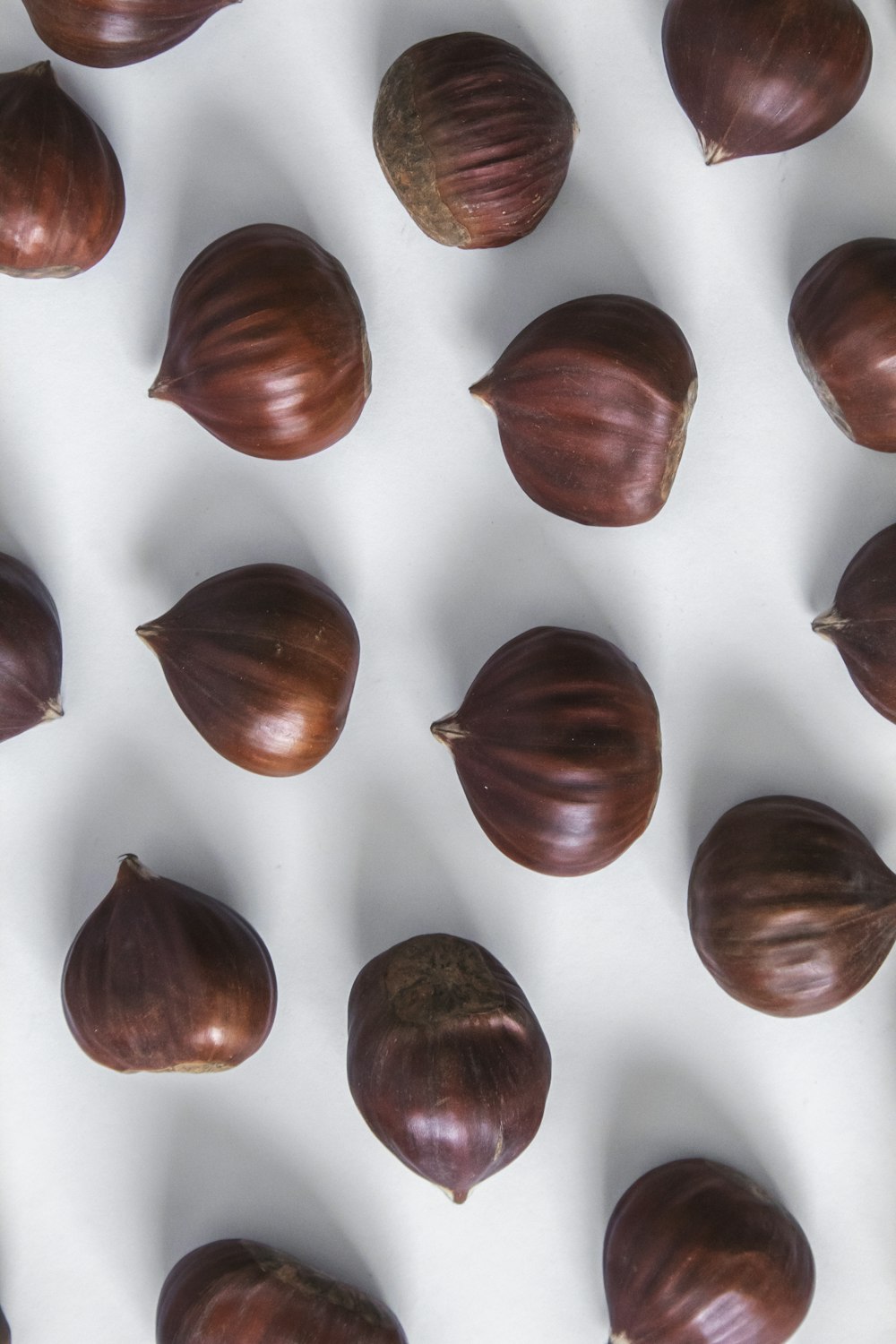 brown round fruits on white and red textile