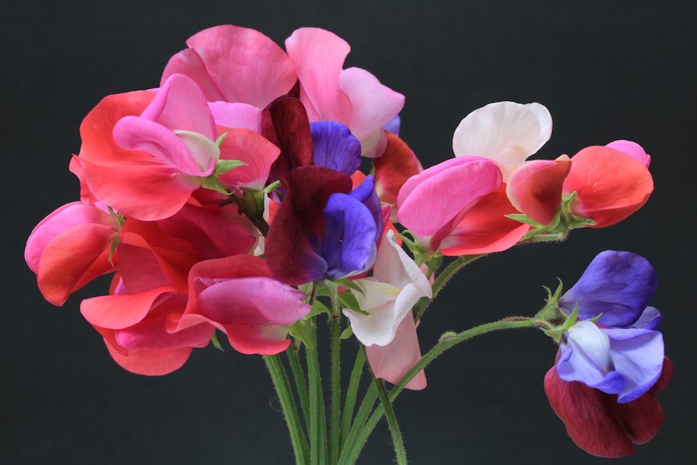 a vase filled with colorful flowers on top of a table