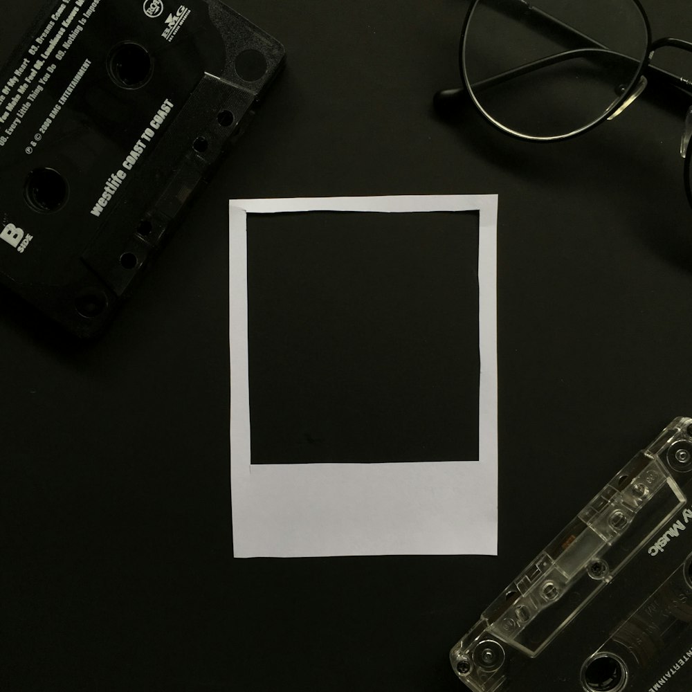 black cassette tape on white printer paper