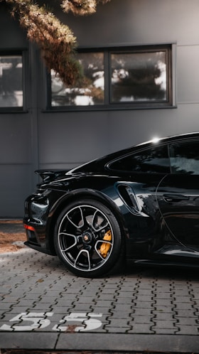 black porsche 911 parked on gray pavement
