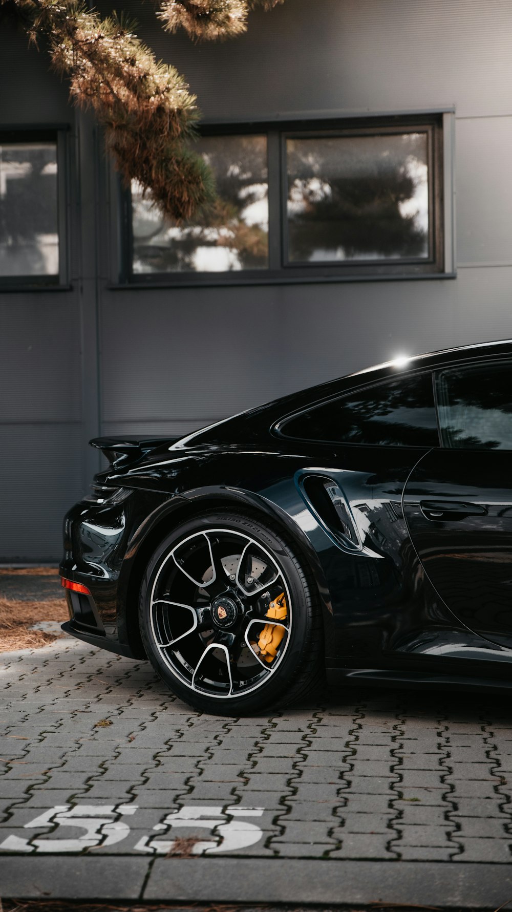 black porsche 911 parked on gray pavement