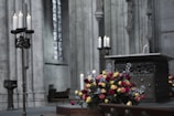A serene altar setup adorned with candles and flowers.