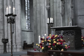 The altar adorned with fresh flowers and classic liturgical items under soft morning light.