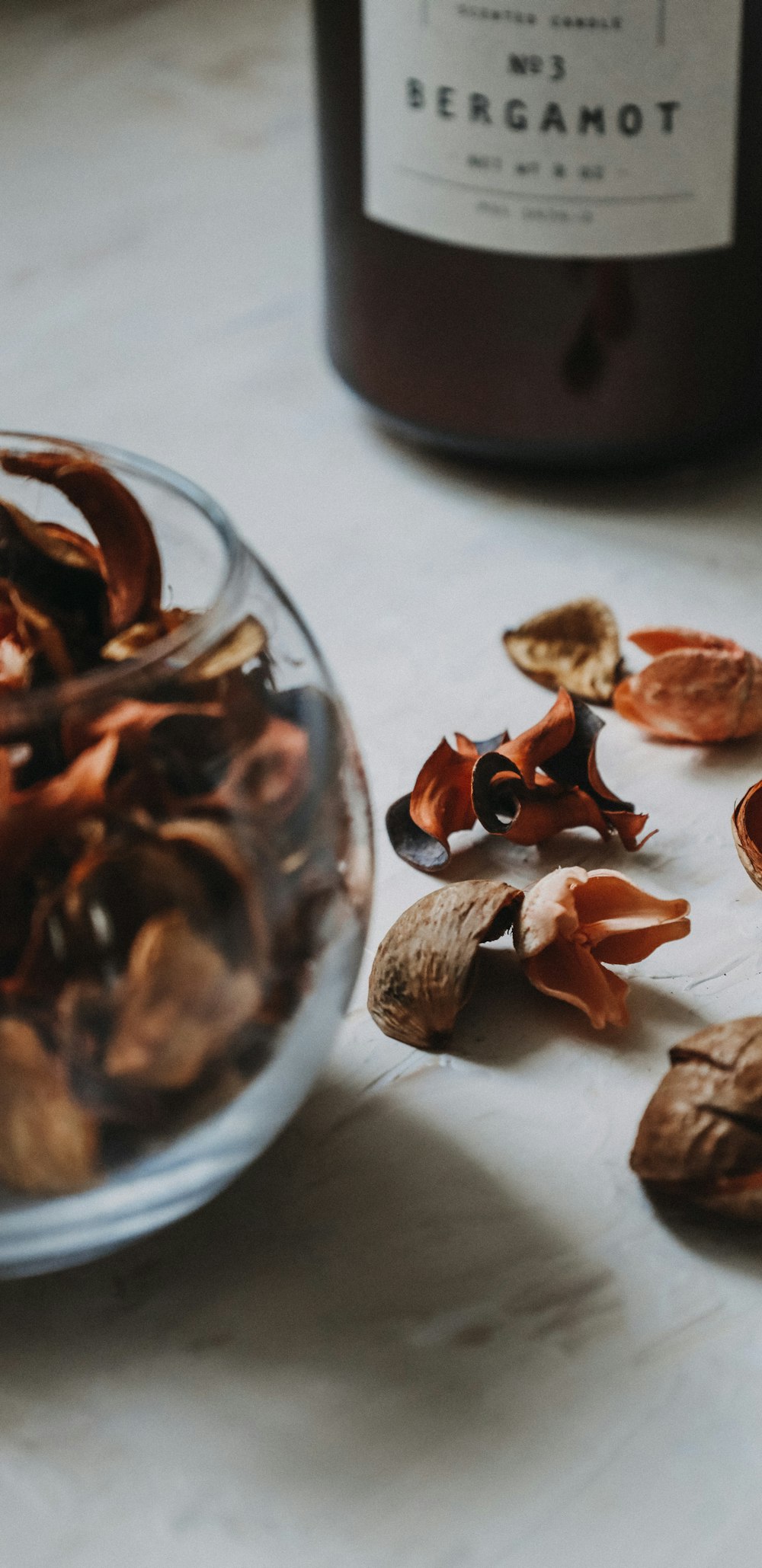 brown and white sea shells on clear glass bowl