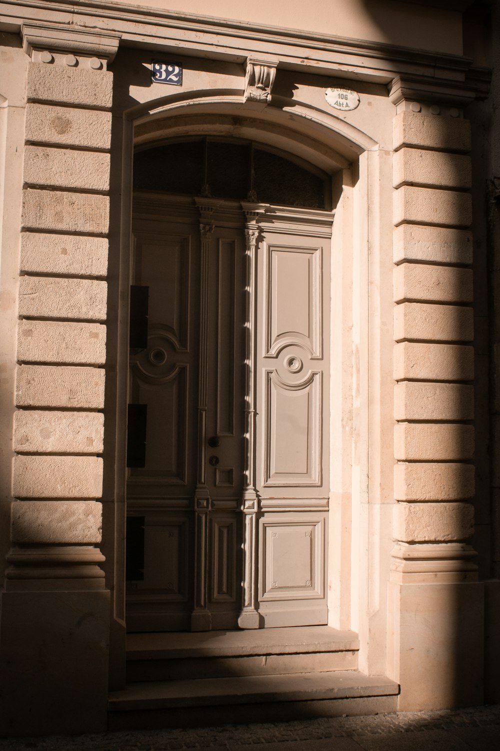 white wooden door on gray concrete wall