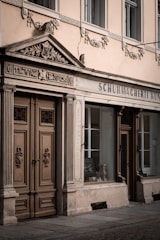 Photo of a hand-painted vintage storefront sign with gold leaf details