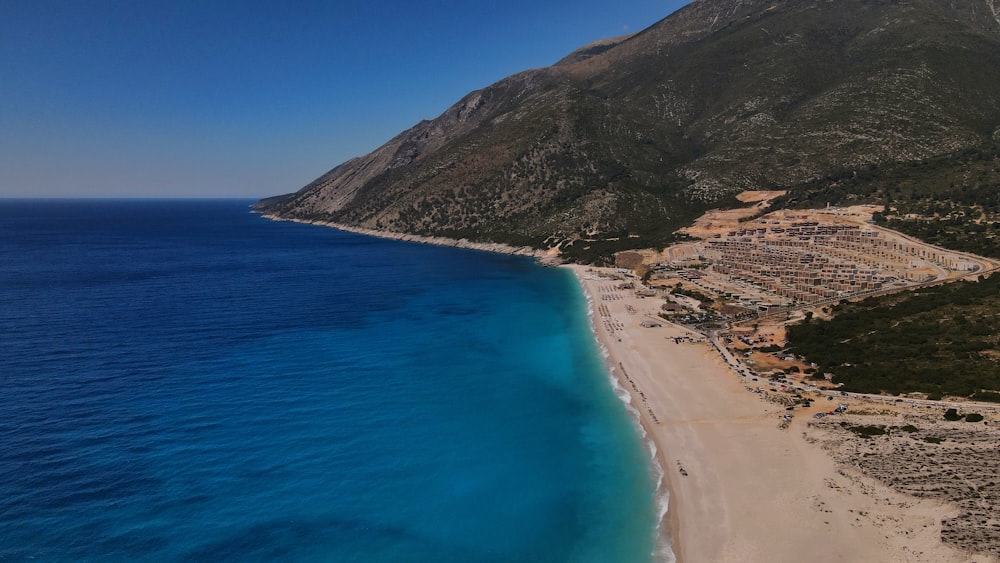 brown mountain beside blue sea during daytime