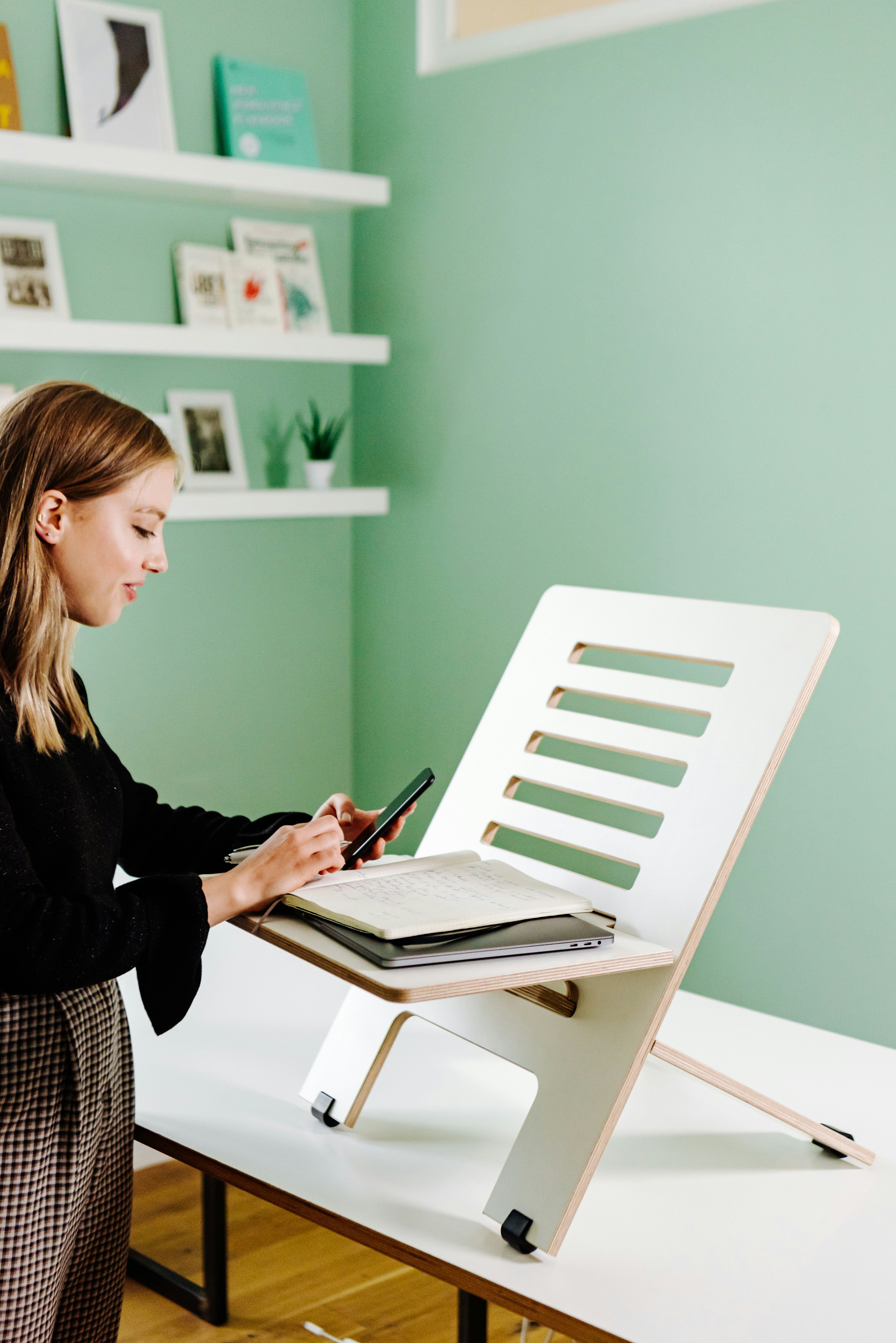 Woman working upright on standing desk - office fit
